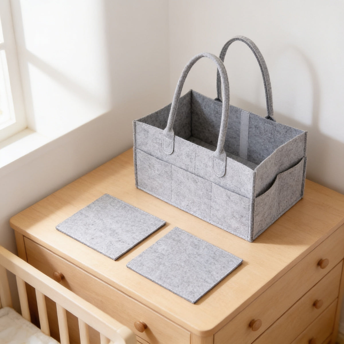 Empty felt diaper caddy with its two removable felt dividers laid out in front of it.