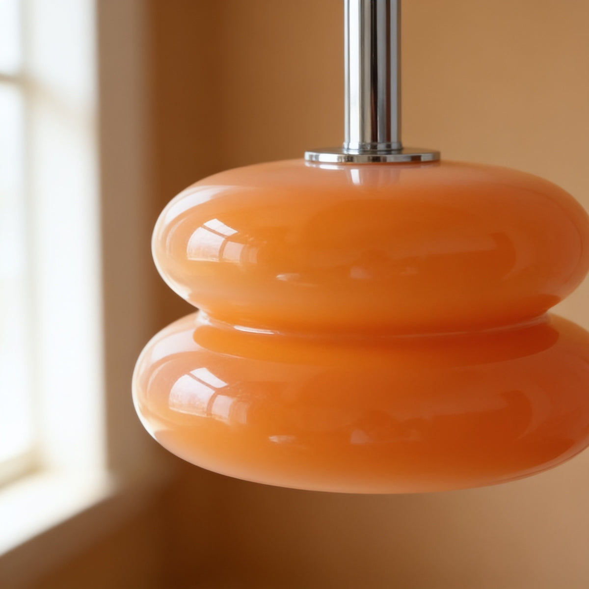Close detail of the glossy orange two-tier opal glass shade.