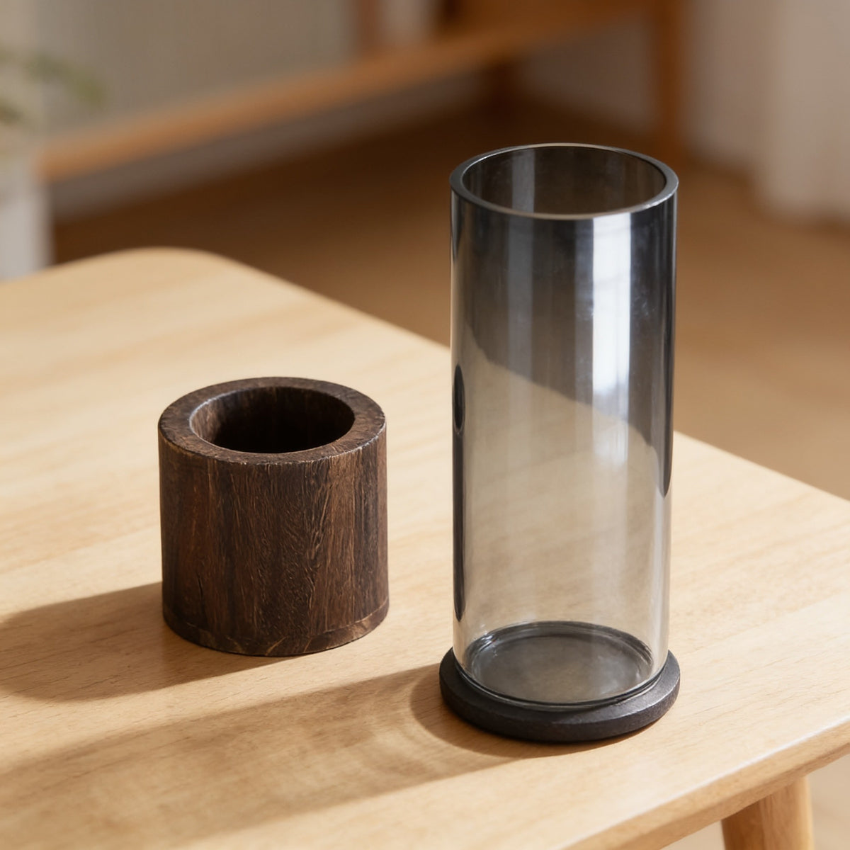 The vase's two parts side by side: the walnut wood base and the smoked glass cylinder lifted out.