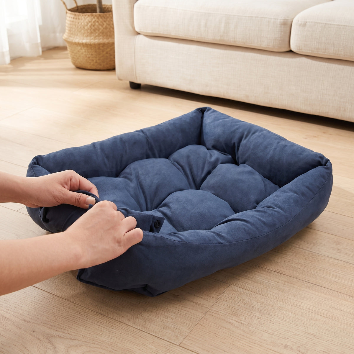 Hands snapping the padded side wall of the pet bed up into its walled shape