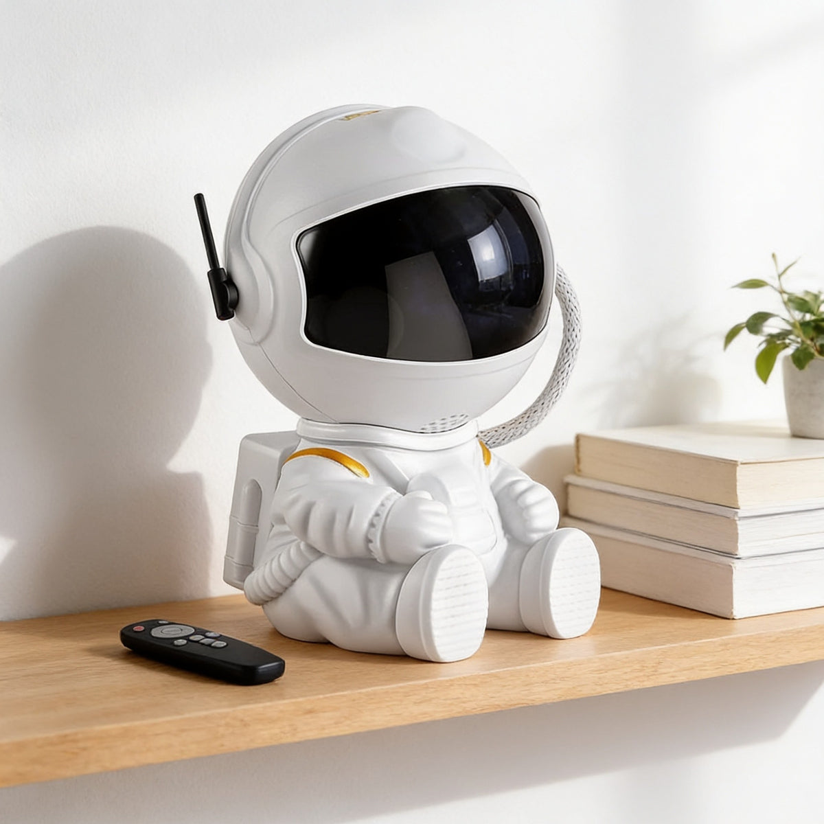 White seated astronaut projector on a shelf in daylight, 12 cm tall.