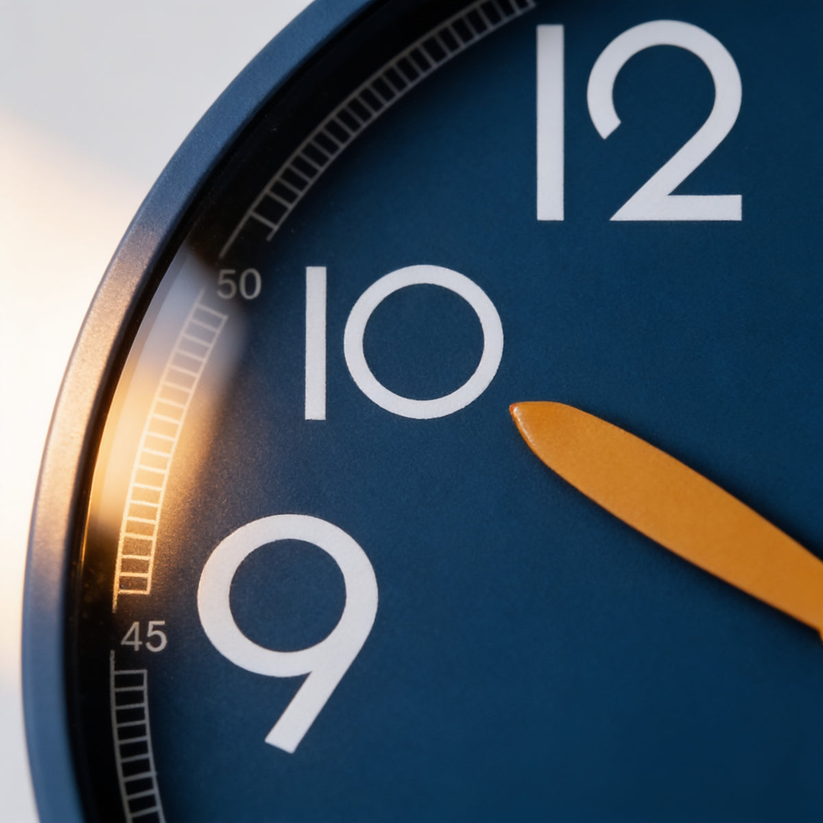 Close-up of the oversized white numerals and amber hour hand on the navy dial