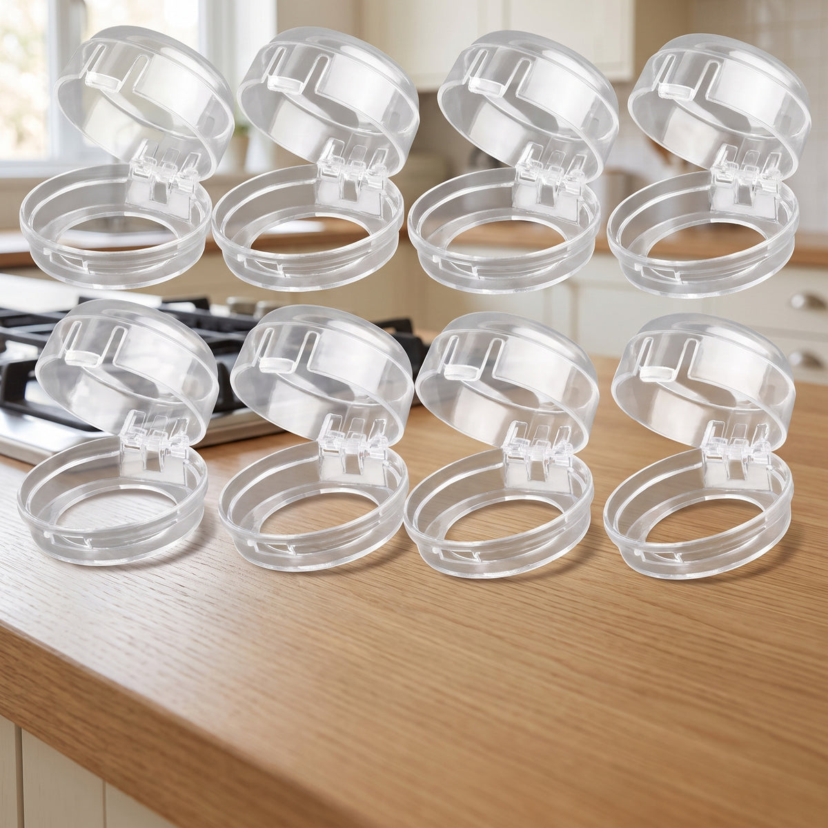Eight clear stove knob covers on a light oak kitchen countertop