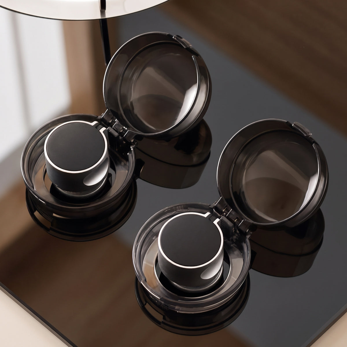 Two installed stove knob covers with their lids open and the knobs inside