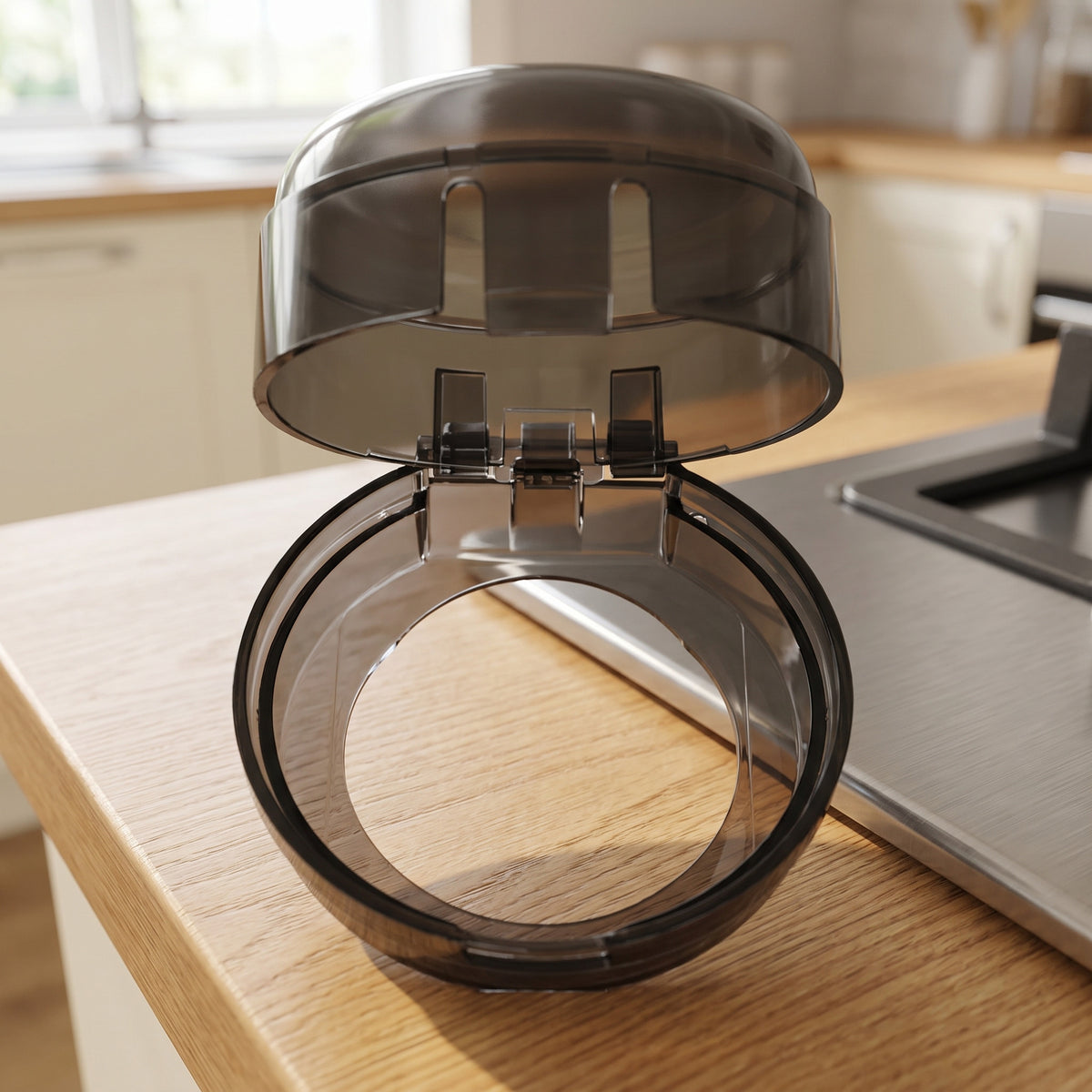 Open stove knob cover showing its hinge, latch slots and round base opening