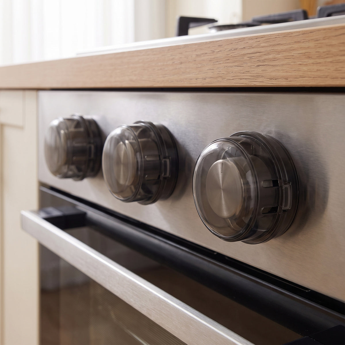 Stove knob covers fitted over the knobs of an oven control panel
