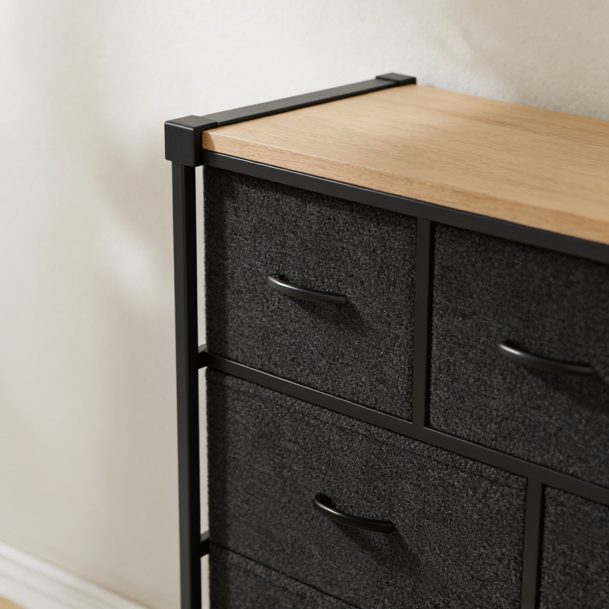 Close detail of the fabric drawer fronts, pull handles and steel frame edge.