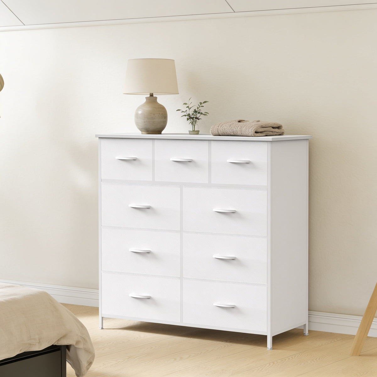 White 9-drawer fabric dresser with steel frame in a bedroom.