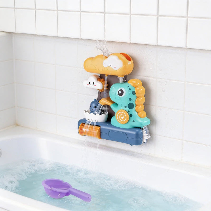 Teal dinosaur waterfall bath toy suctioned to the tile wall above the bath, water flowing, purple scoop floating.