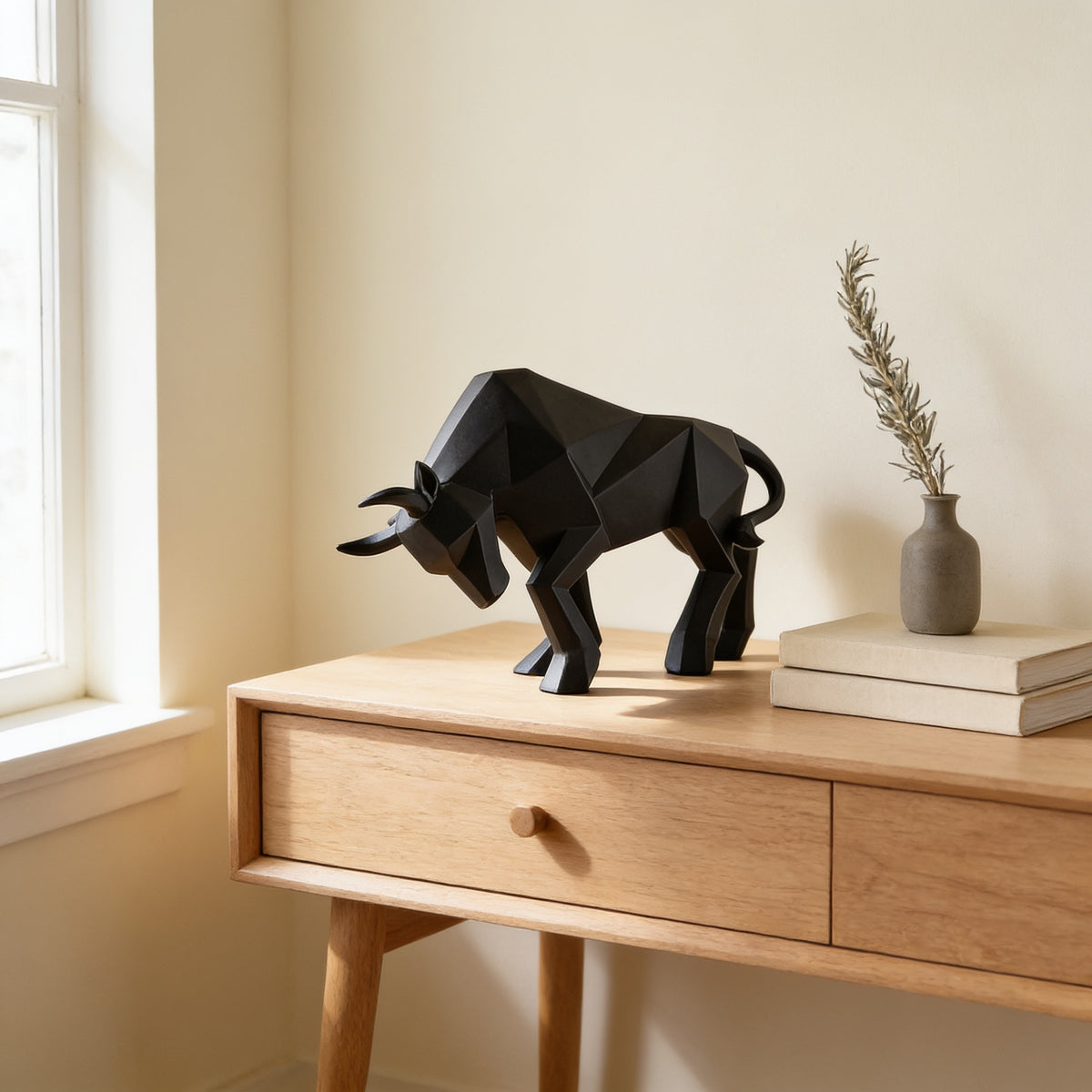 Black faceted geometric bull statue, large charging pose, on an oak console — Faceted Geometric Bull Statue