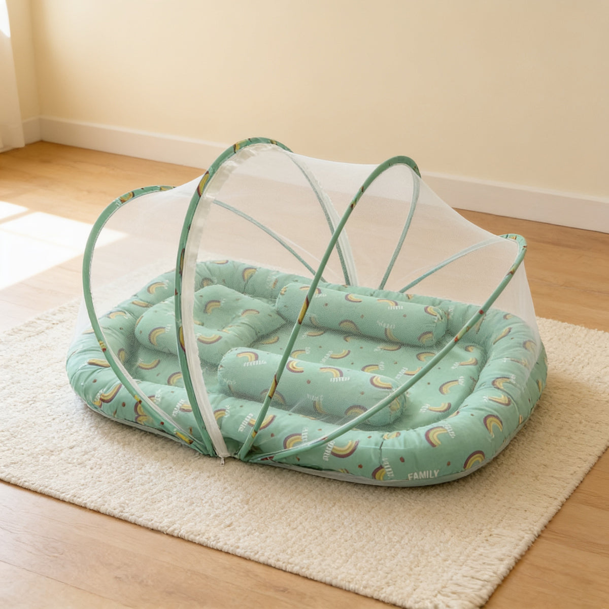 Green Rainbows foldable travel bassinet, green cotton with rainbow arcs, with its mesh net dome up on a cream rug in a bright living room