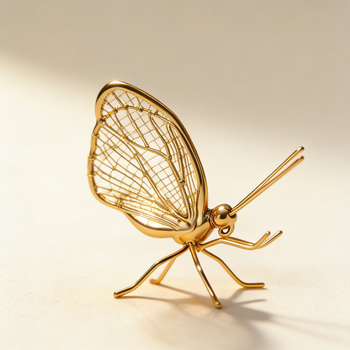 Close-up of the butterfly's gold wire-mesh wing — Gold Metal Insect Figurine, Ant or Butterfly