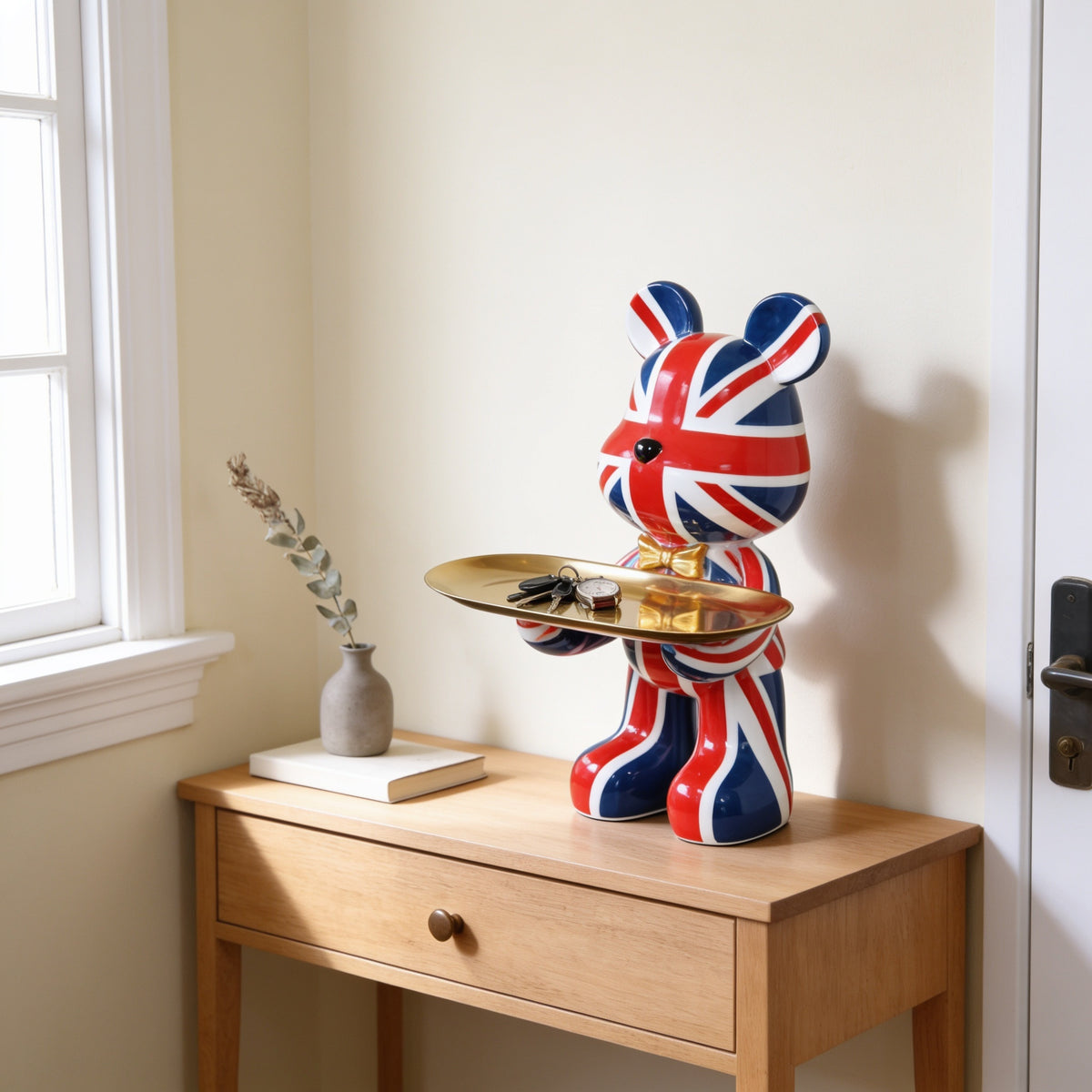 Union Jack splash graffiti bear statue holding a gold tray on an entryway console
