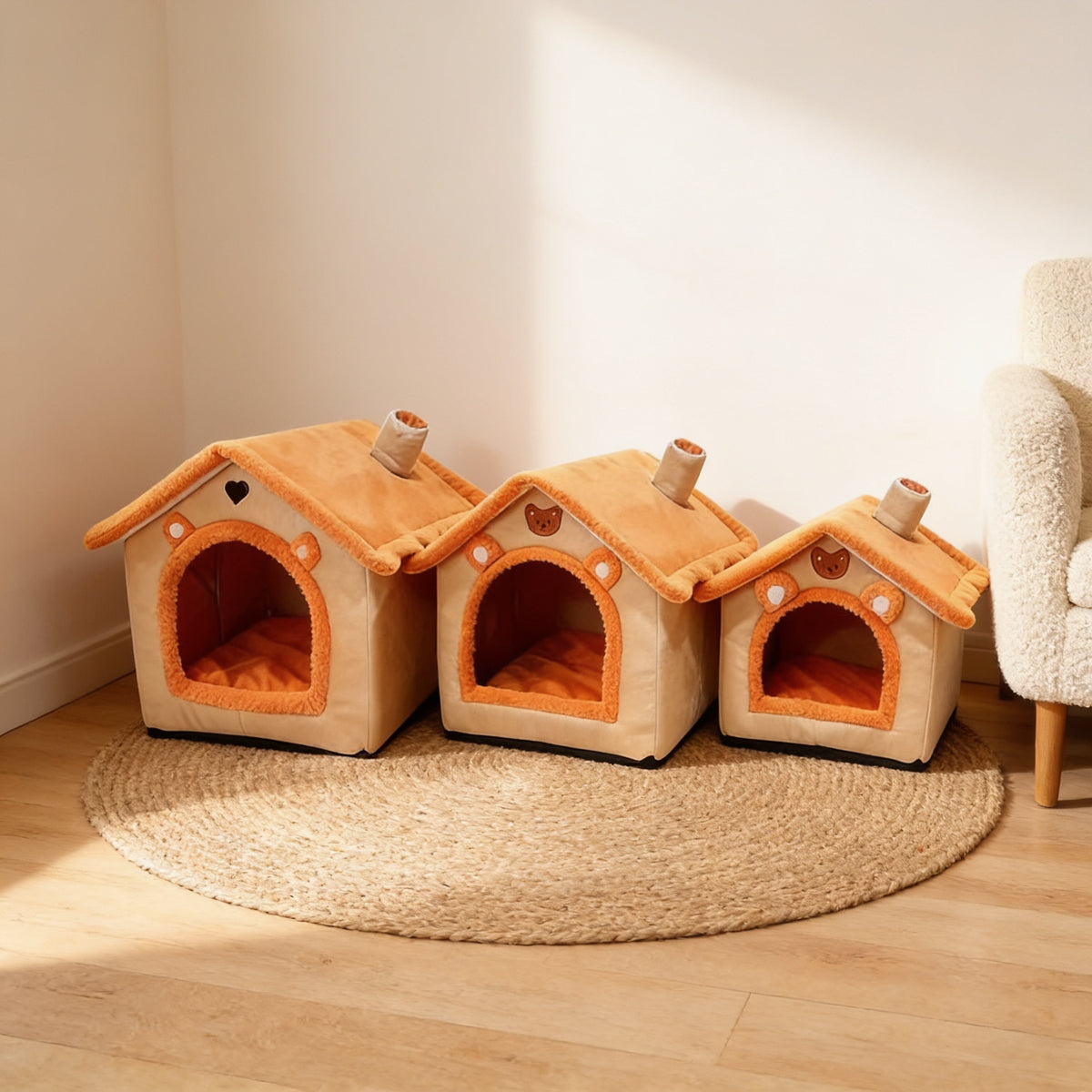 Large, medium and small orange house-shaped covered pet beds side by side on a jute rug