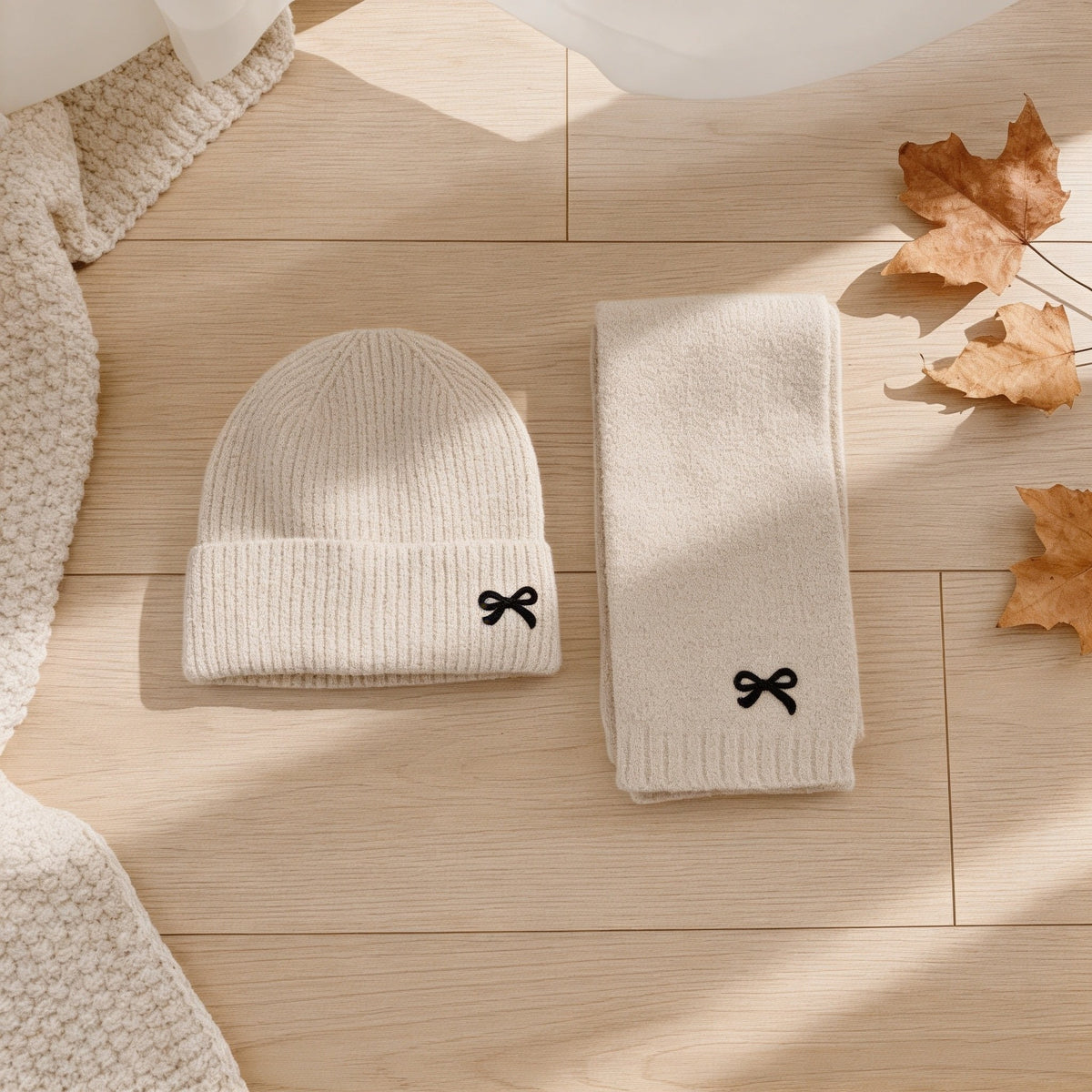 Oatmeal ribbed knit kids hat and scarf set with embroidered bows.