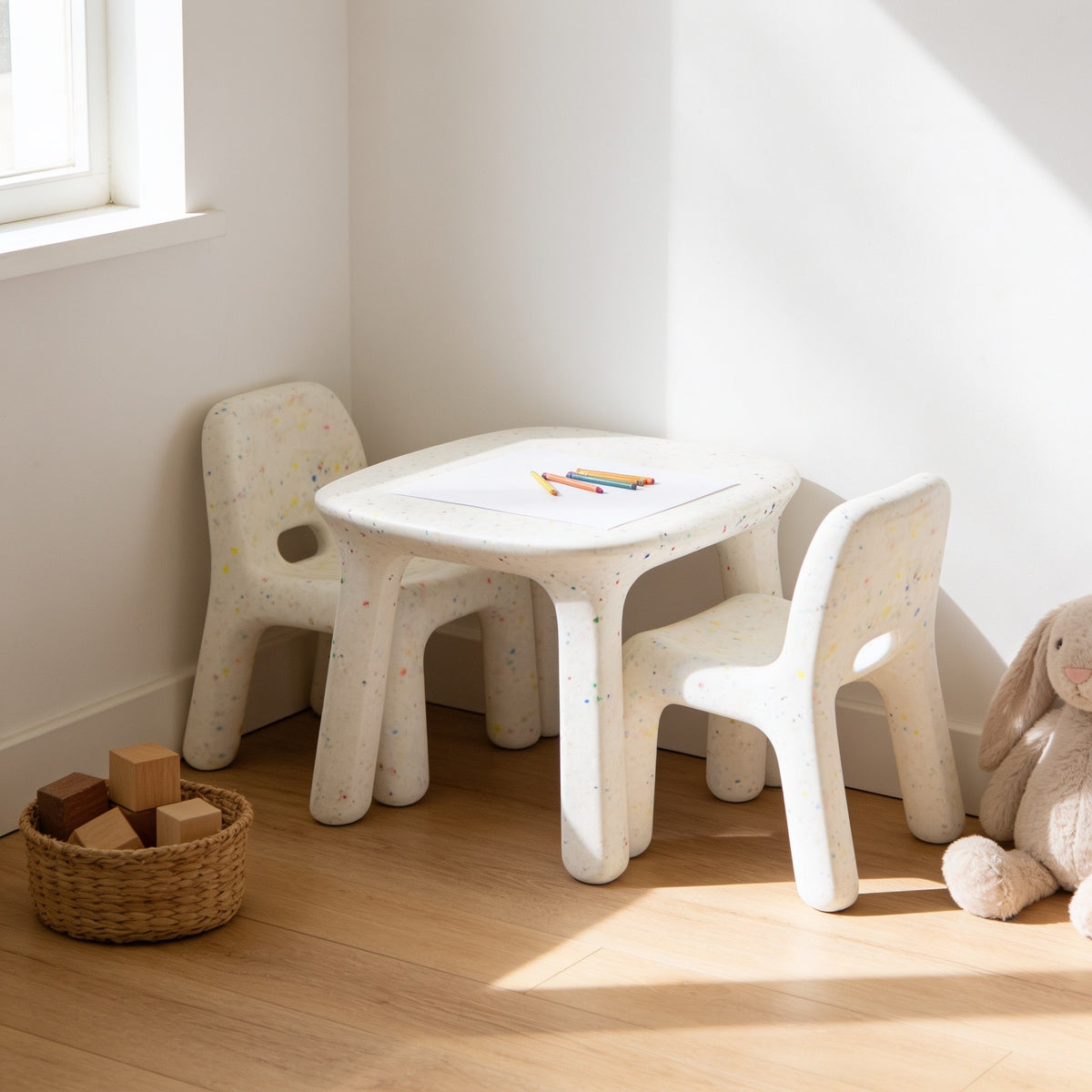 White speckled kids table with white & white speckled chairs in a sunny kids room.