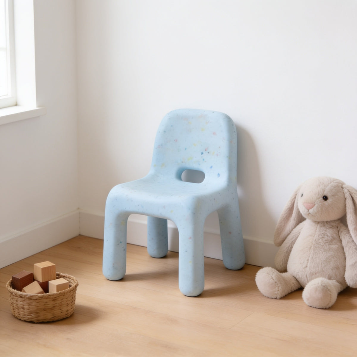 Light Blue (Low) speckled molded kids chair with a hand-hole backrest in a sunny kids room.
