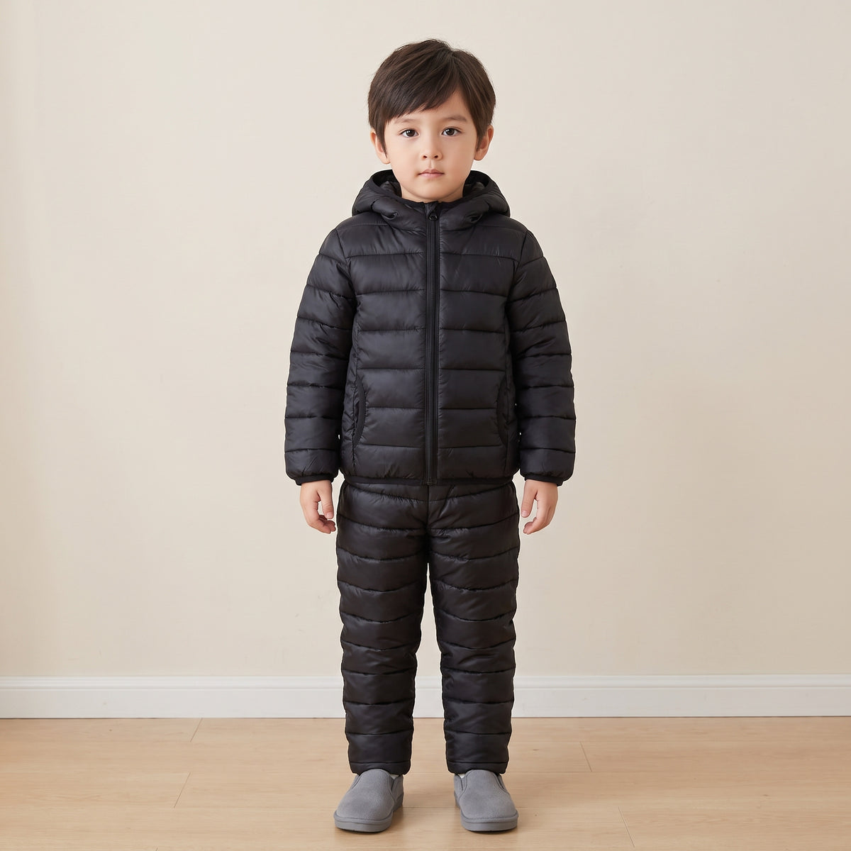Child wearing the complete two-piece set, full length against a plain wall