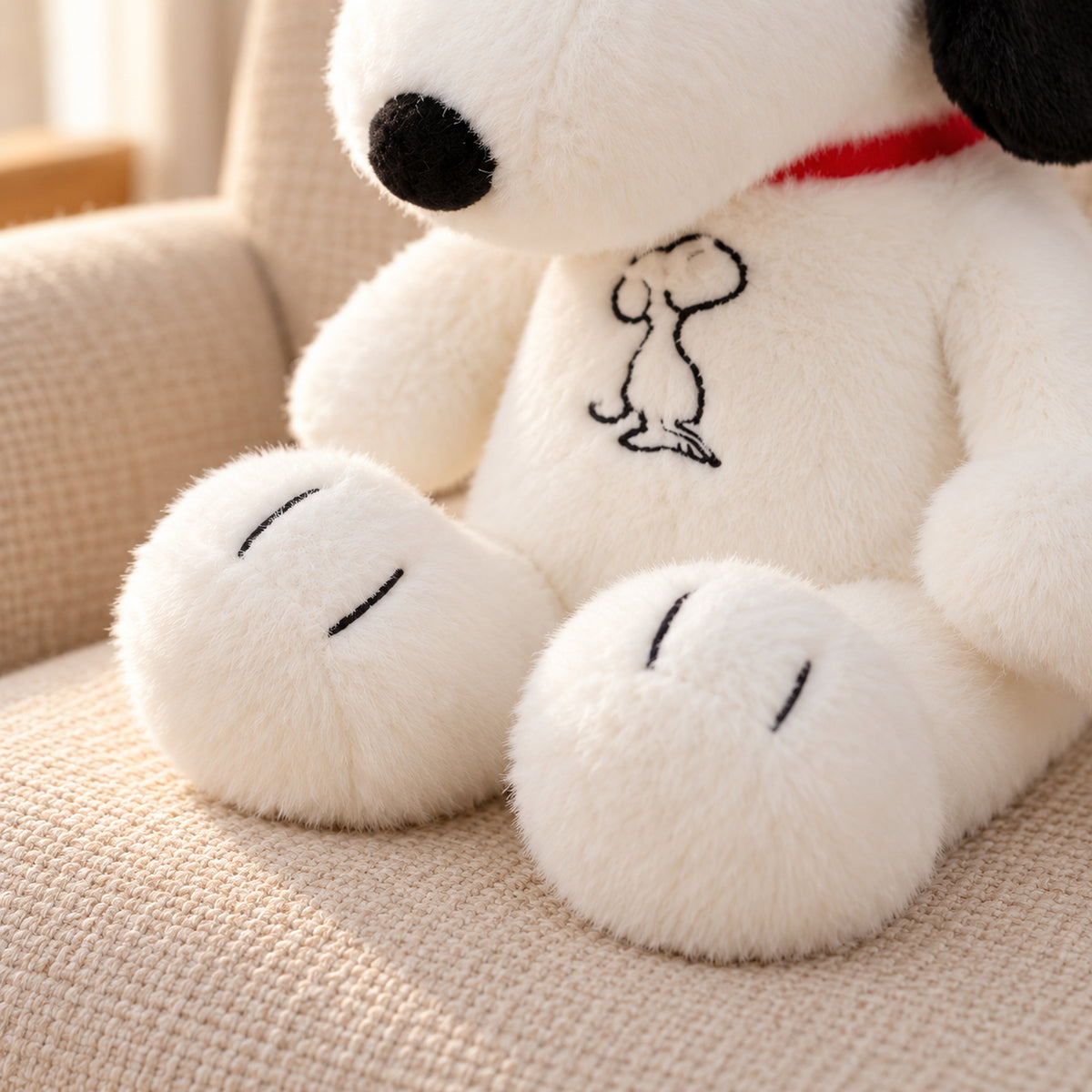 Close-up of the puppy plush two rounded feet with two black toe stitches on each