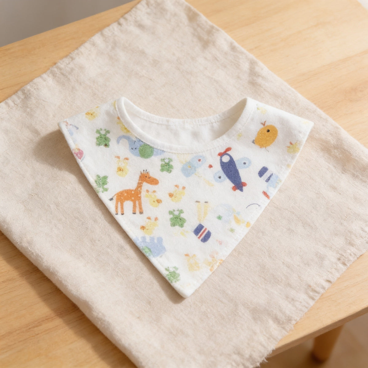 Add-on cotton bandana bib with a random colorful animal print, laid flat.