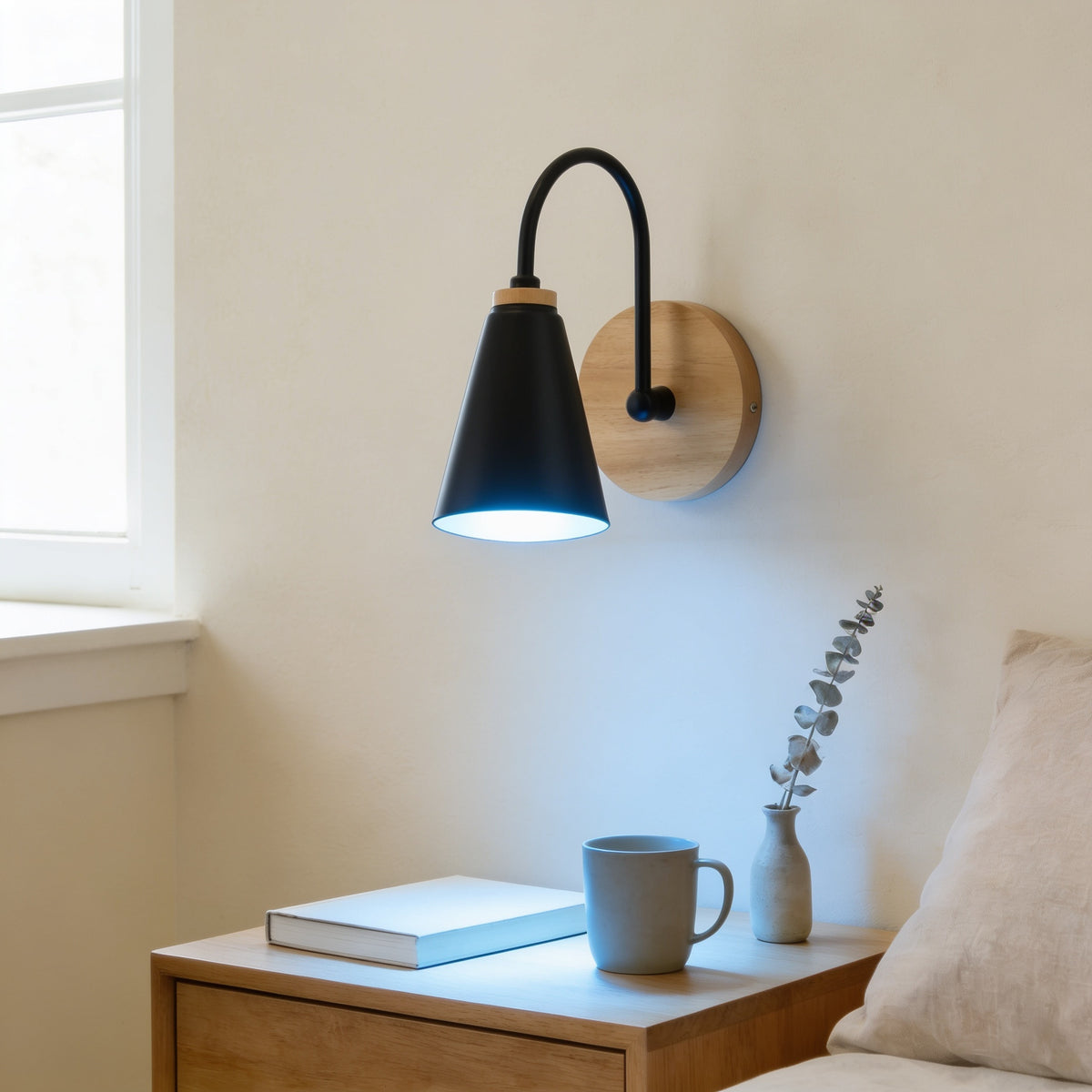 Black cone wall sconce lit cool white above an oak nightstand — Nordic Wood & Metal Cone Wall Sconce