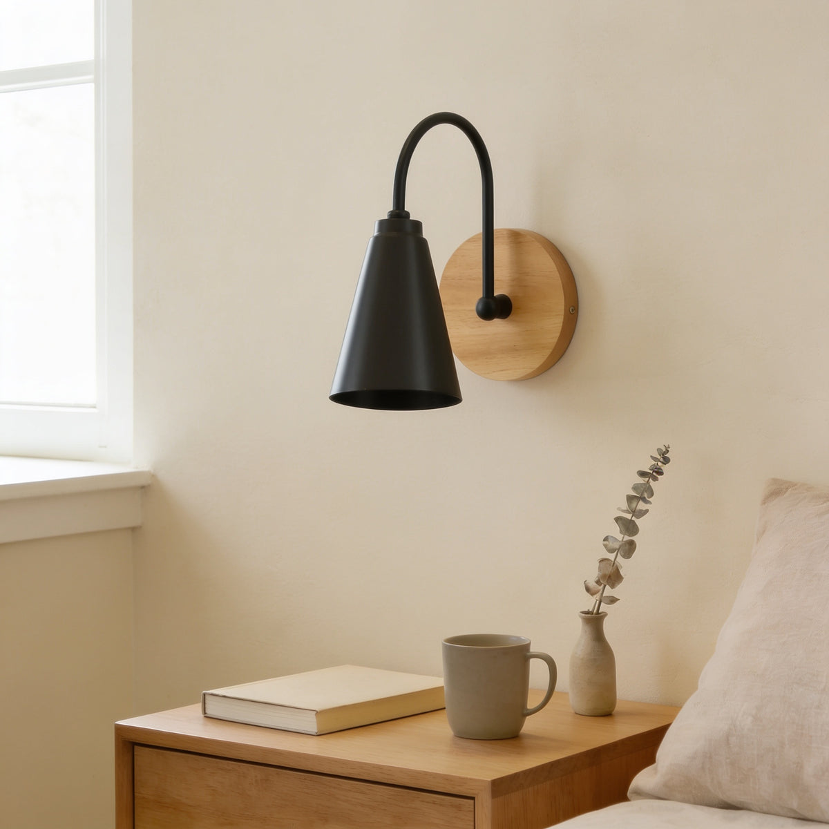 Black cone wall sconce with solid wood base, switched off, above an oak nightstand — Nordic Wood & Metal Cone Wall Sconce