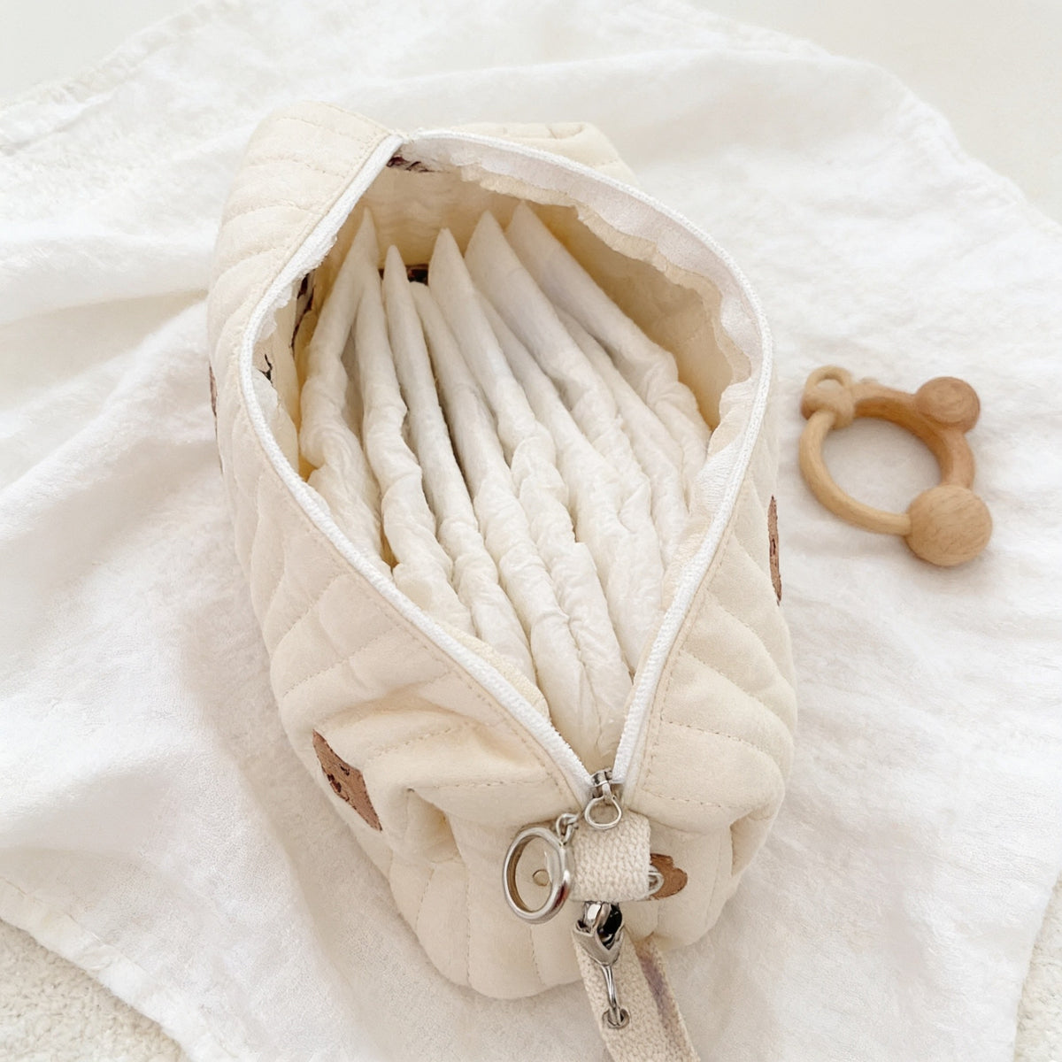 Diaper pouch open showing folded diapers standing upright inside.