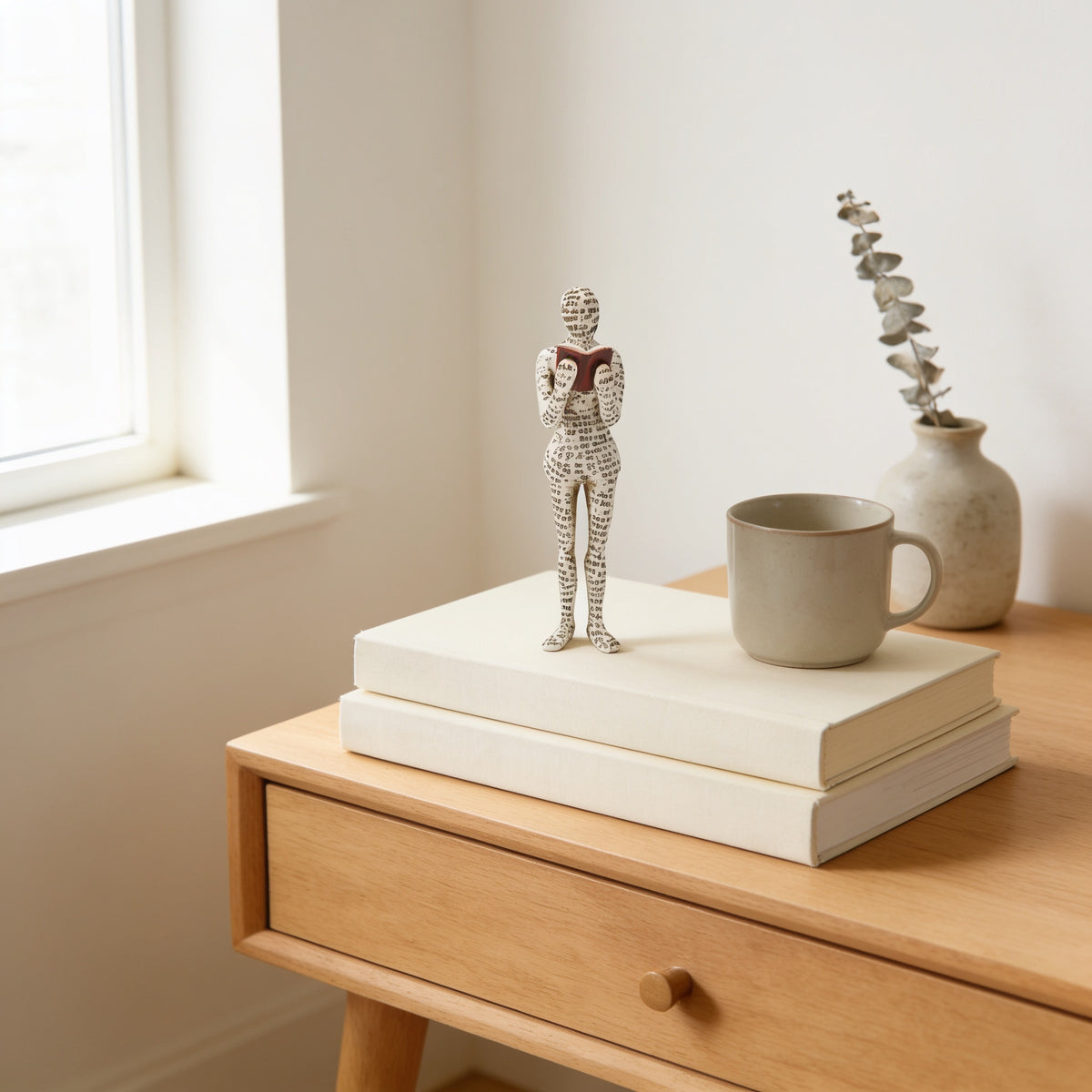 Standing paper-pulp reading figurine on stacked books — Paper-Pulp Reading Figurine