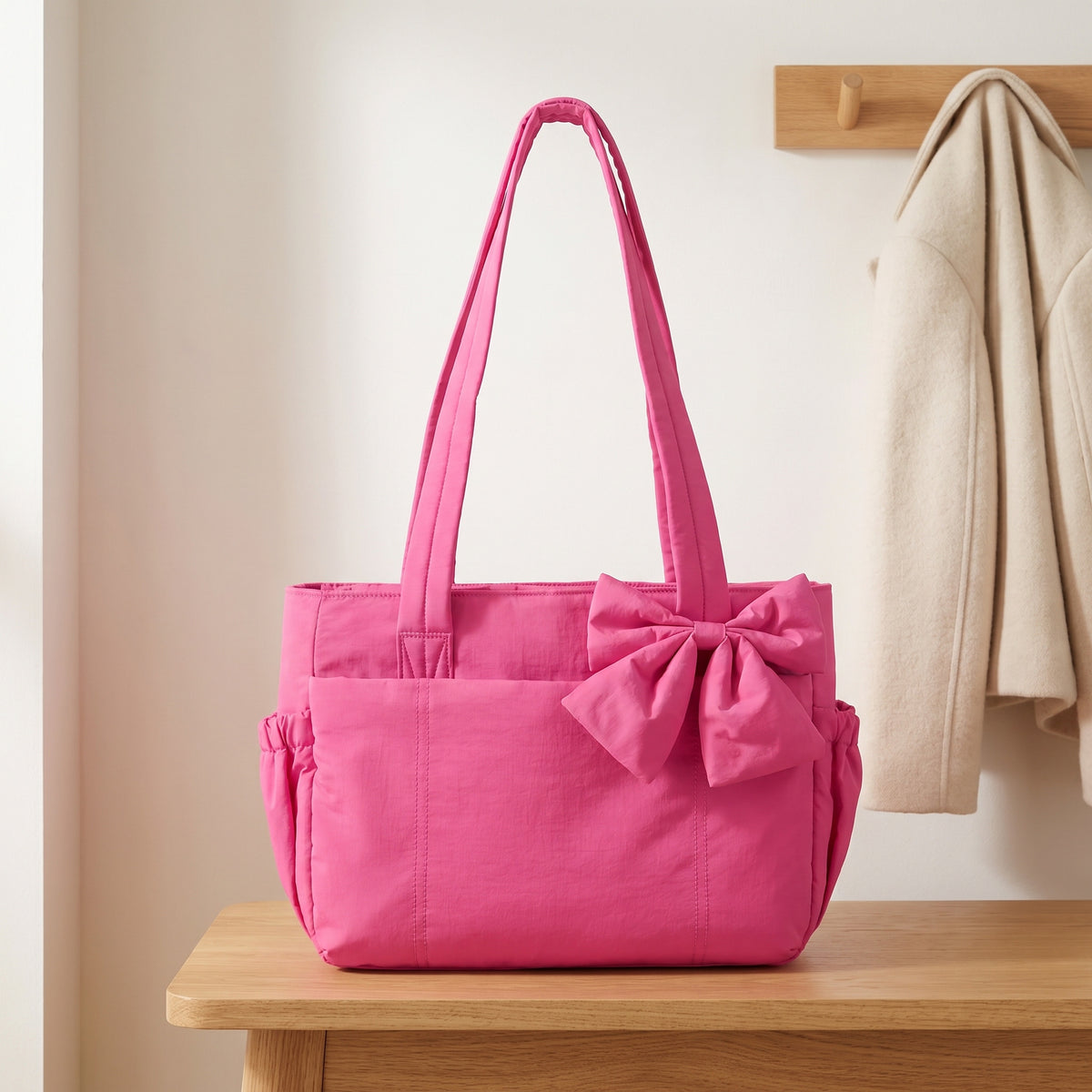 Fuchsia puffer laptop tote bag with a bow on an entryway bench