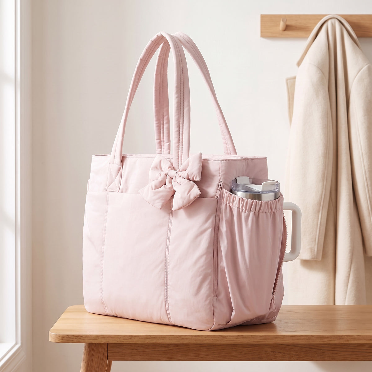 Tumbler standing in the tote's side pocket with its handle out through the side zip (15.6in shown, tumbler not included)