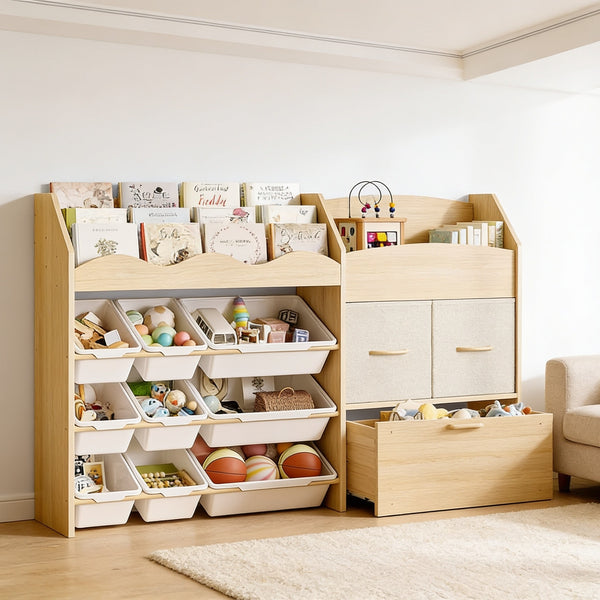 Scalloped toy storage organizer in a living room: wavy book shelf over nine white bins, two beige fabric drawers and a rolling toy chest, 140 cm wide and 90 cm tall.