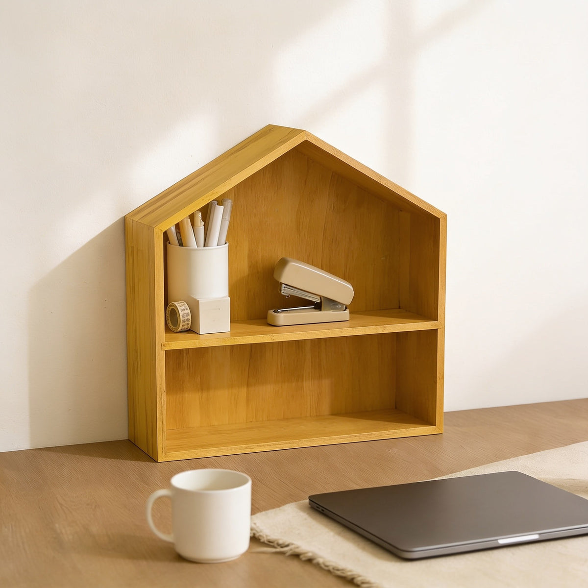 Large natural wood house-shaped desk shelf on a home-office desk.
