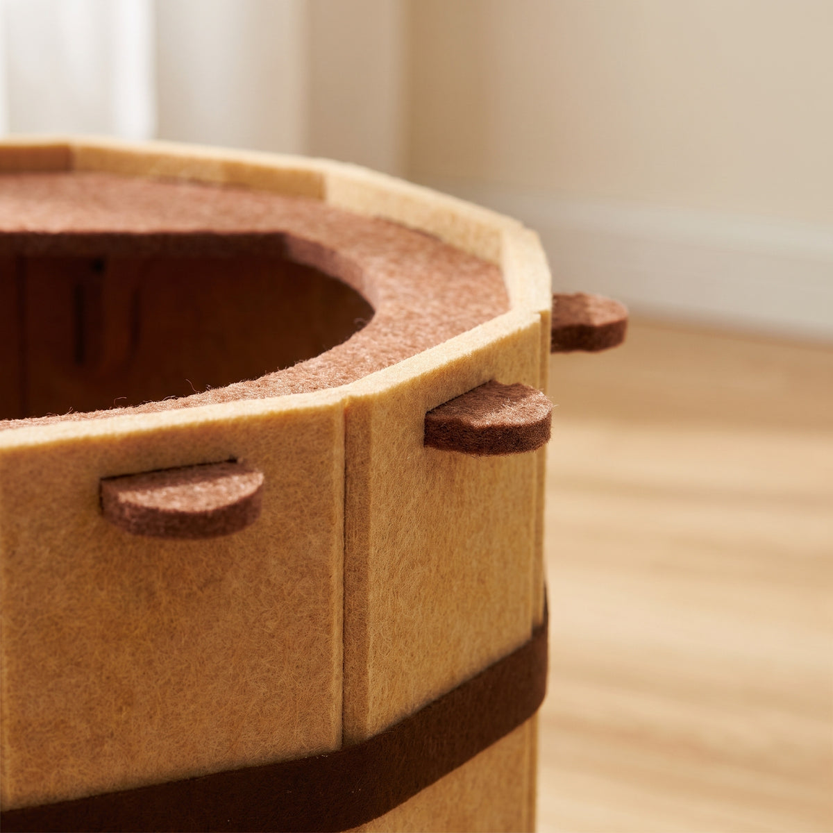 Close-up of the felt rim ledge, staves and pushed-through tabs on the cat bed wall