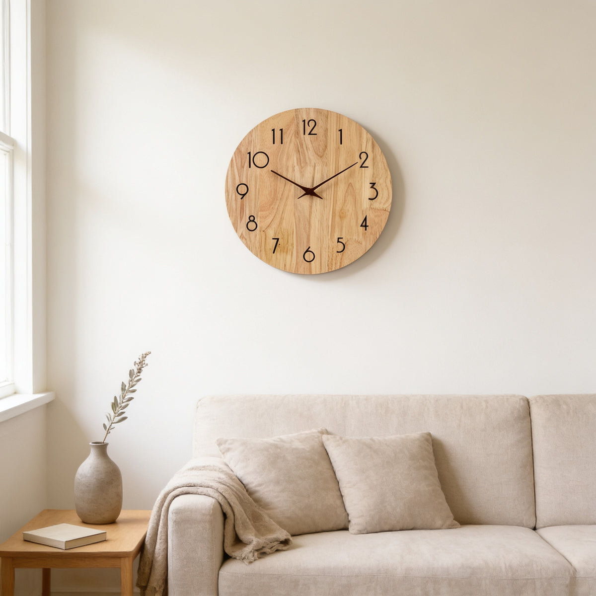 Round natural wood wall clock with full 1 to 12 numerals above a linen sofa — Silent Natural Wood Wall Clock