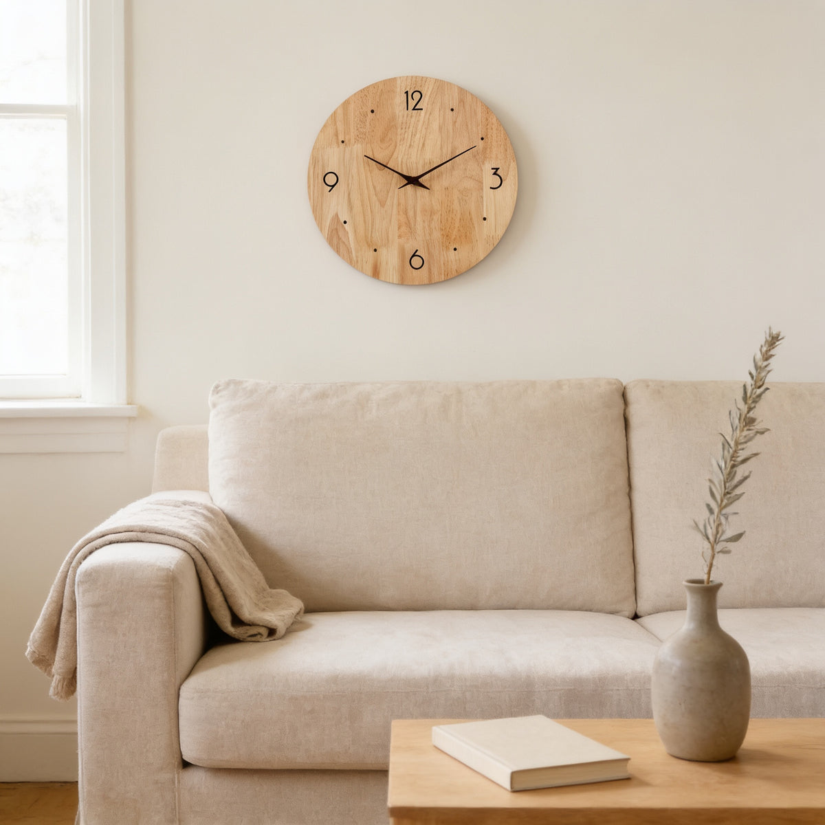 Round natural wood wall clock with 12 3 6 9 numerals and dots above a linen sofa — Silent Natural Wood Wall Clock