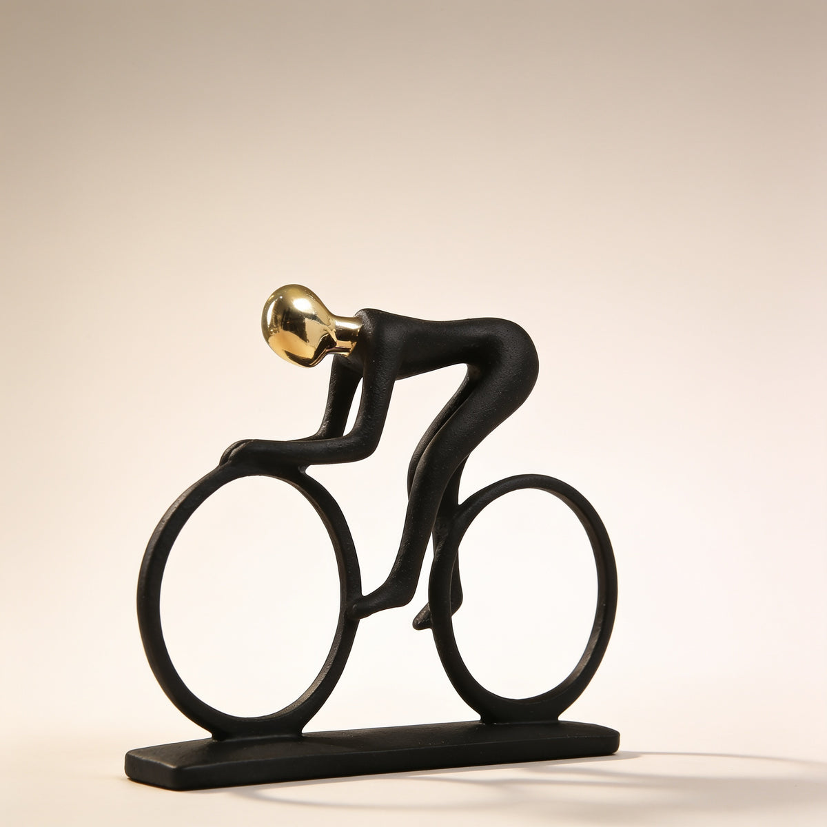 Cyclist pose, black and gold resin figurine on cream background — Black & Gold Sports Figurine