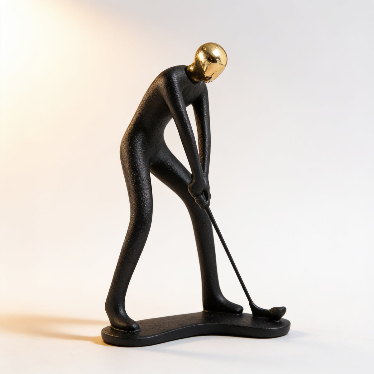 Golfer putting pose, black and gold resin figurine on cream background — Black & Gold Sports Figurine
