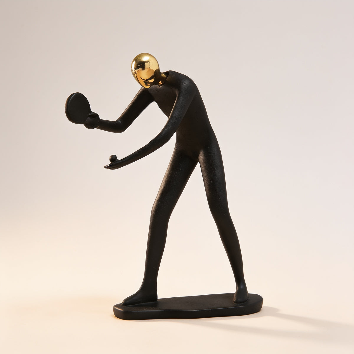 Table tennis pose, black and gold resin figurine on cream background — Black & Gold Sports Figurine