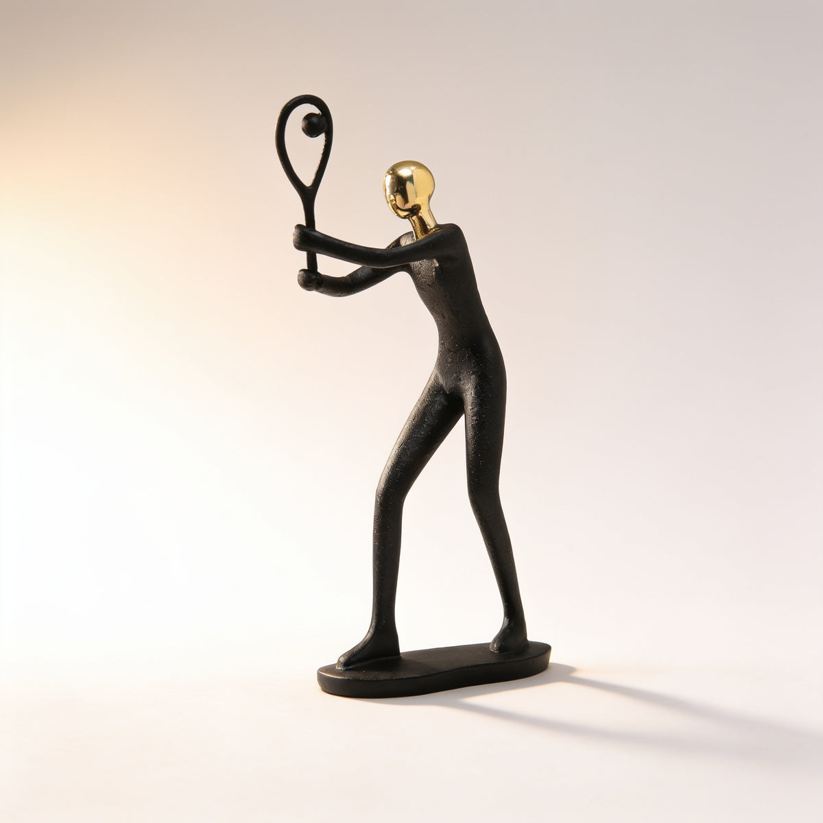 Tennis player pose, black and gold resin figurine on cream background — Black & Gold Sports Figurine