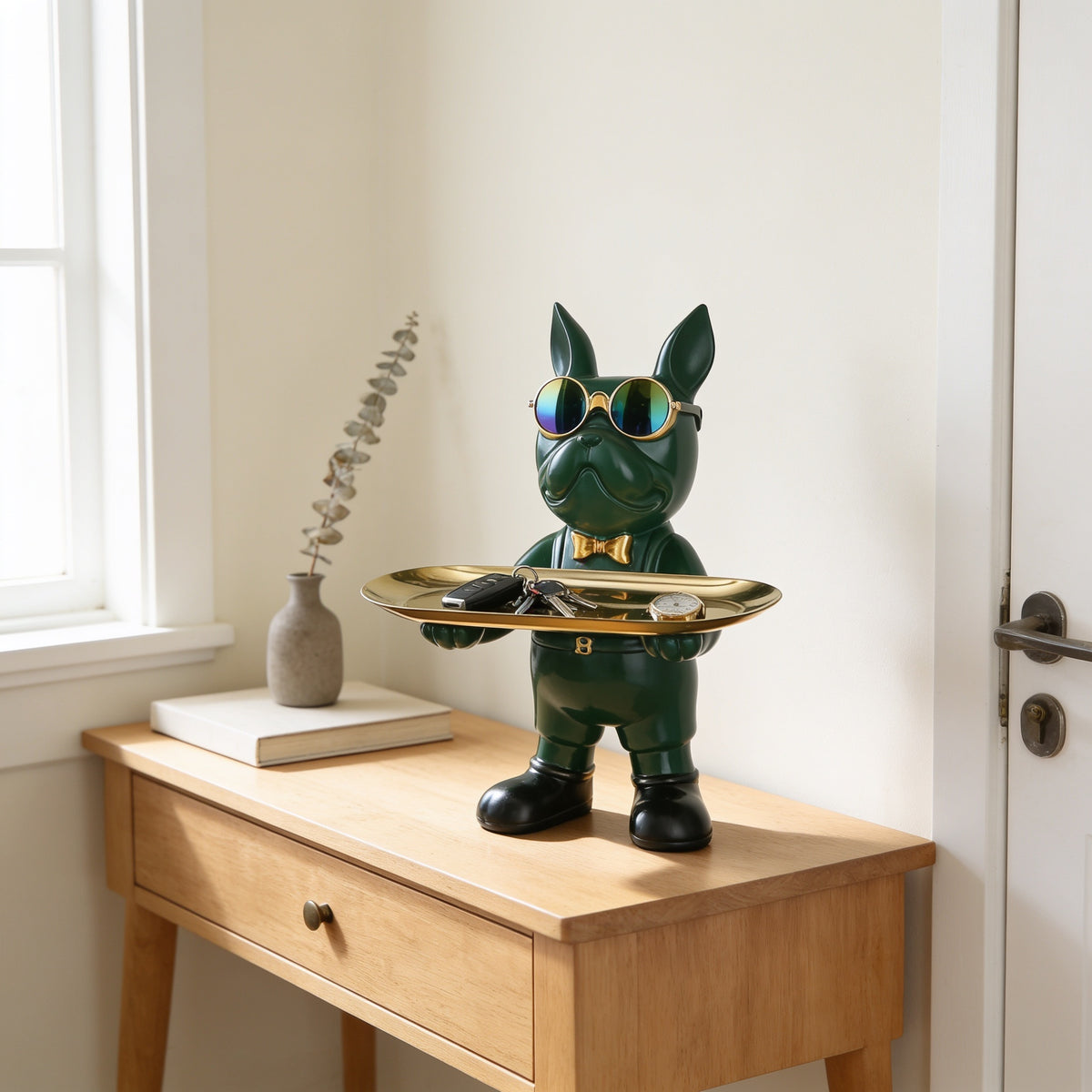 Green standing French bulldog butler statue holding a tray on an entryway console