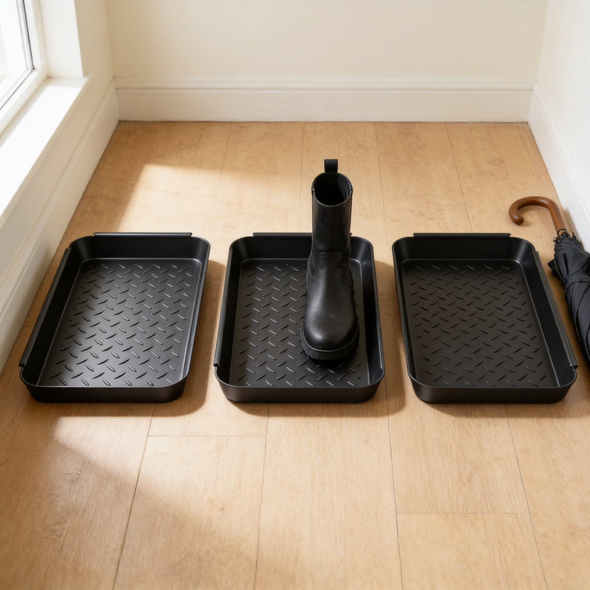 All three textured boot trays lined up on an entryway floor