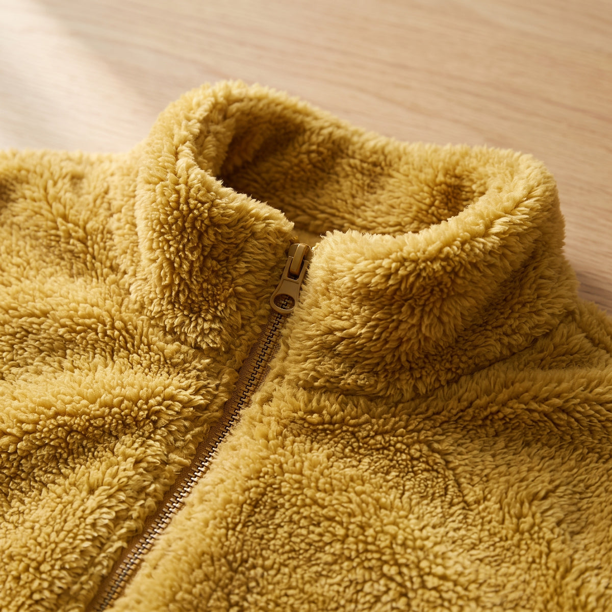 Close-up of the stand collar and full-length metal zip on the fleece jacket