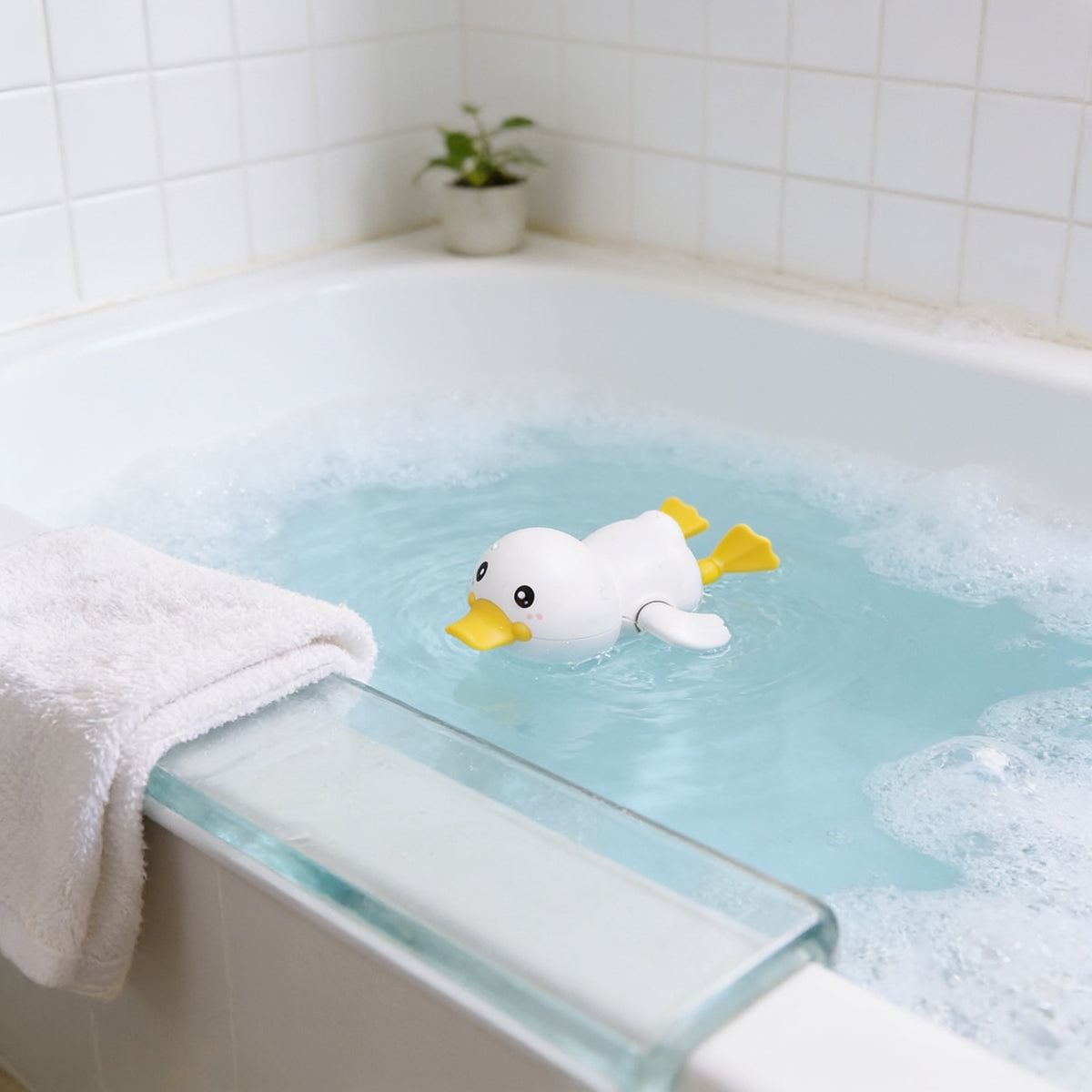 Wind-Up Duck, White toddler bath toy in a bright bathtub.