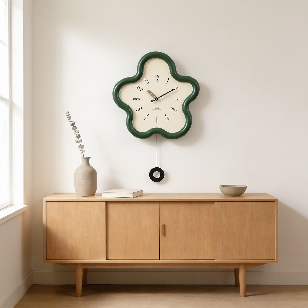 Green flower-shaped wall clock with swing pendulum above an oak sideboard — Wavy Flower-Shaped Wall Clock