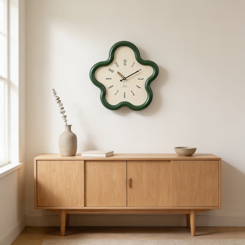 Green wavy flower-shaped wall clock above an oak sideboard with a vase and book — Wavy Flower-Shaped Wall Clock