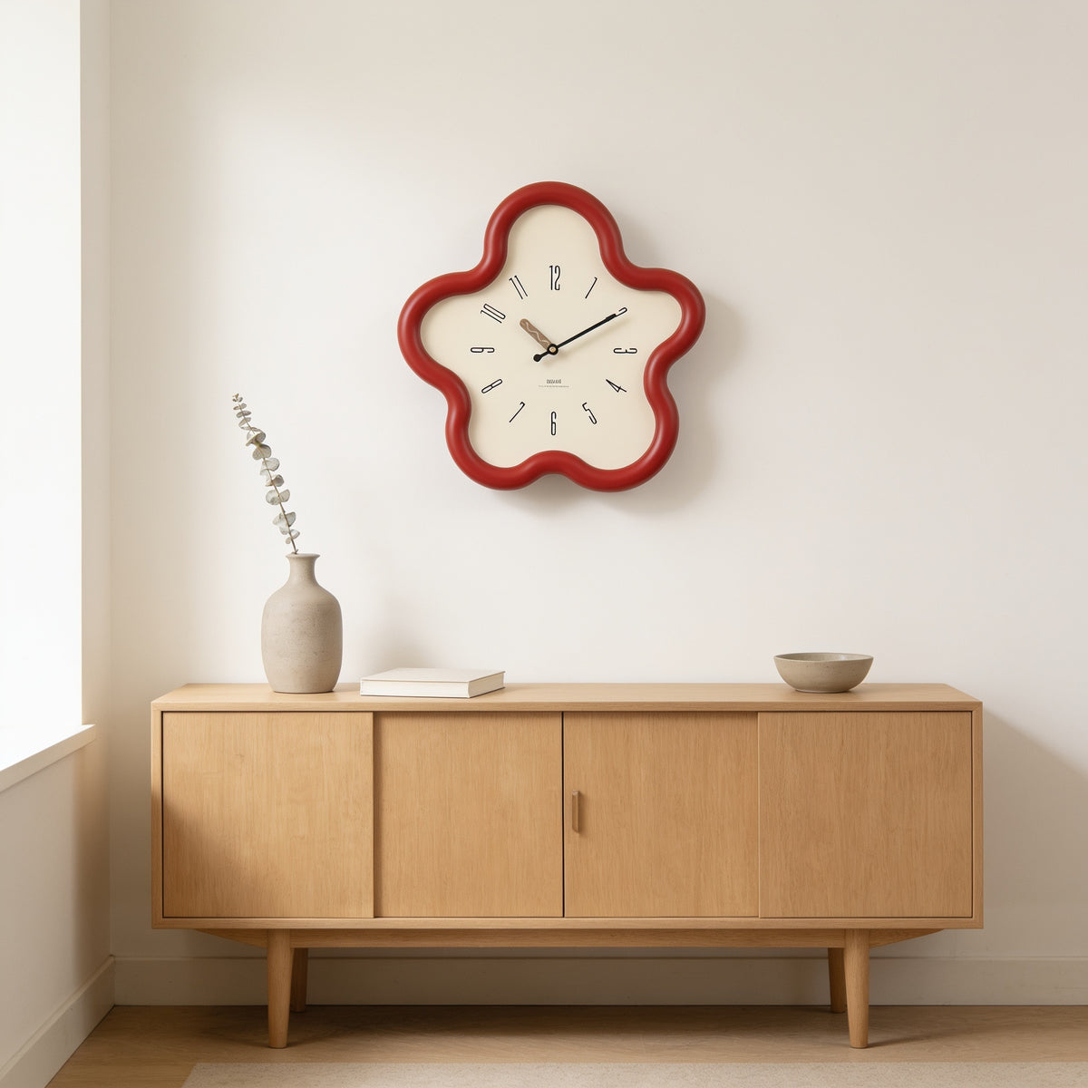 Red flower-shaped wall clock above an oak sideboard — Wavy Flower-Shaped Wall Clock