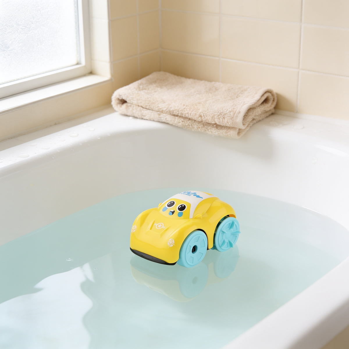 Yellow wind-up car bath toy floating on clear water in a white bathtub