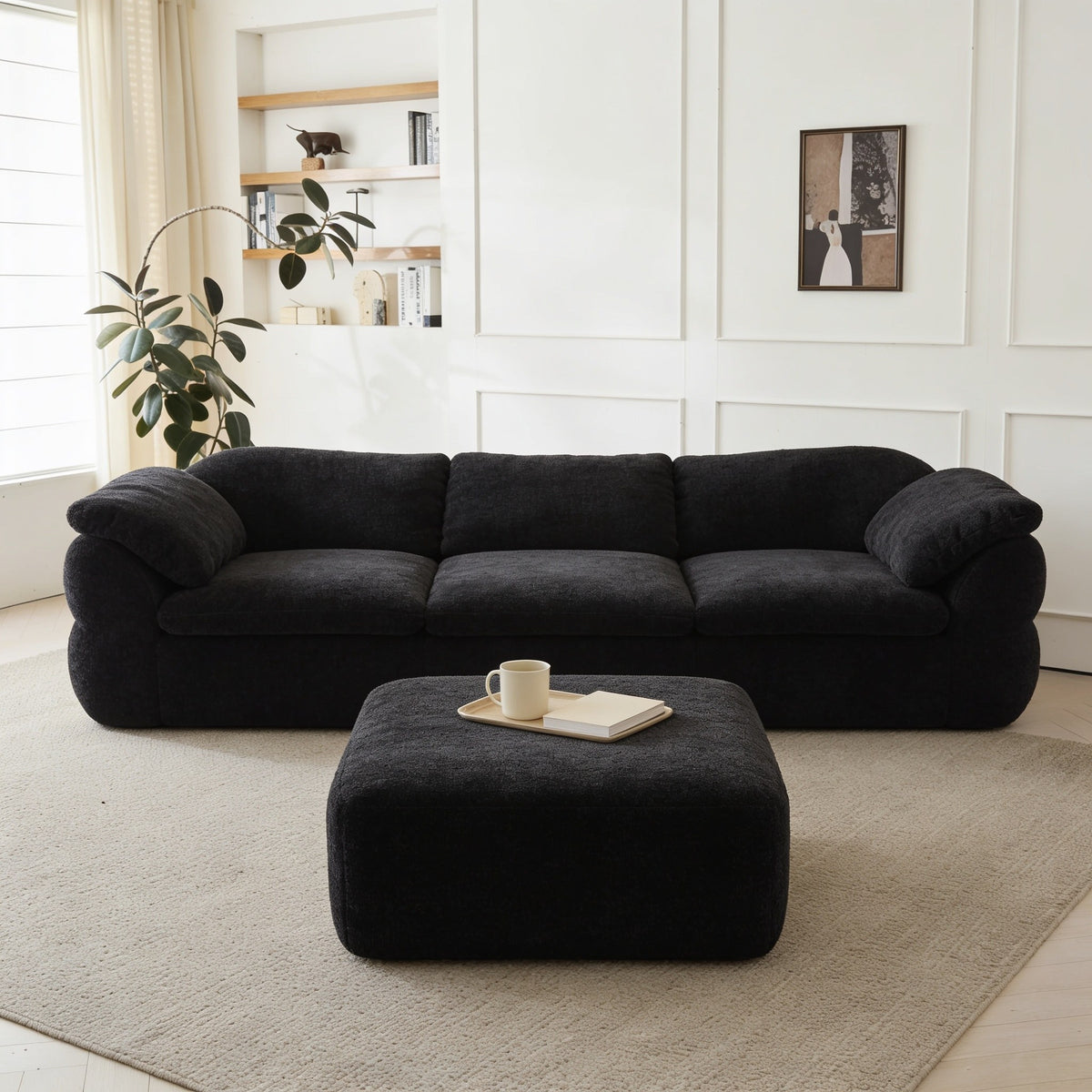 Black chenille modular cloud couch with ottoman.
