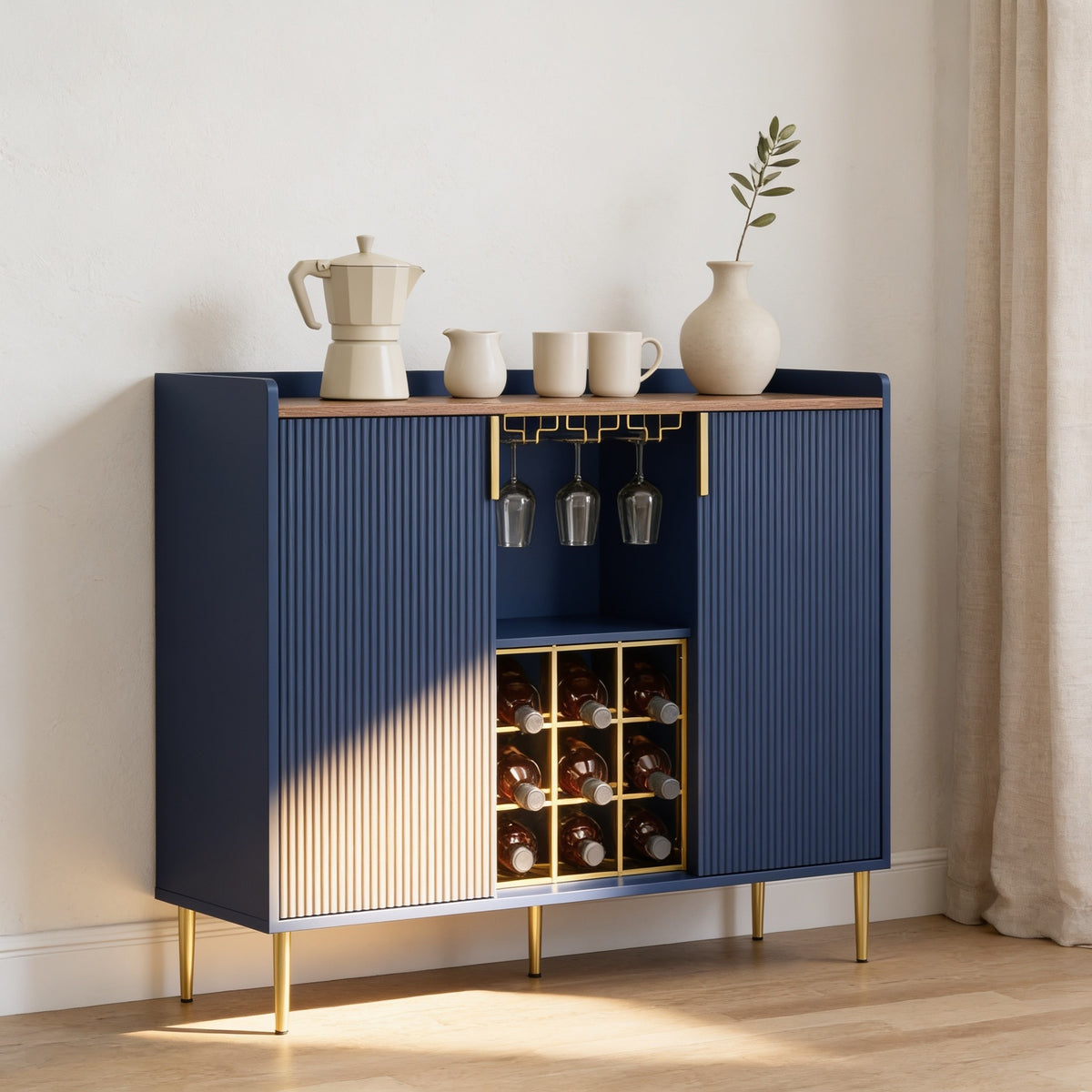 Navy blue fluted coffee bar cabinet with walnut top, gold fittings and a nine-bottle wine rack.